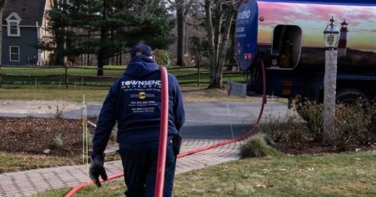 Townsend Energy technician facilitating oil delivery