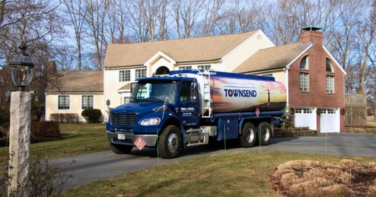 fuel delivery truck parked outside a home