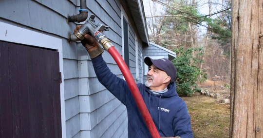 Townsend oil delivery technician refilling a tank