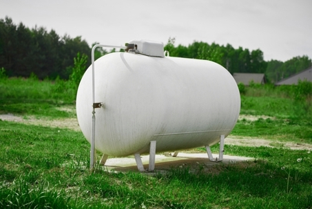 White propane tank at a home.