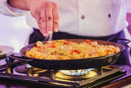 image of a homeowner cooking with propane stove