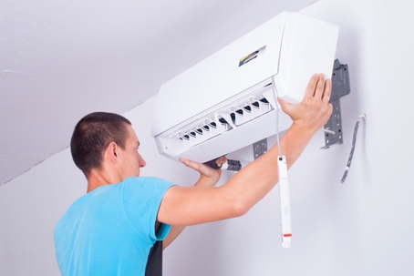 a technician repairing the split type AC