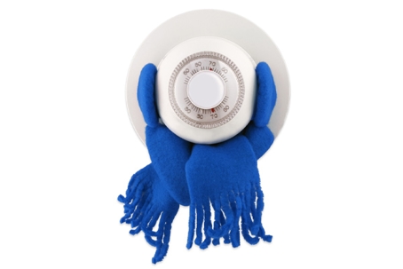 A white, round thermostat