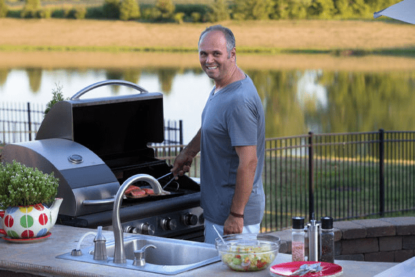 image of an outdoor kitchen with a propane grill