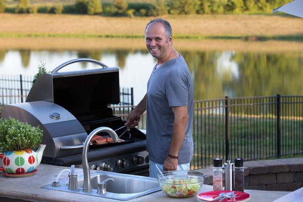 image of an outdoor kitchen with a propane grill