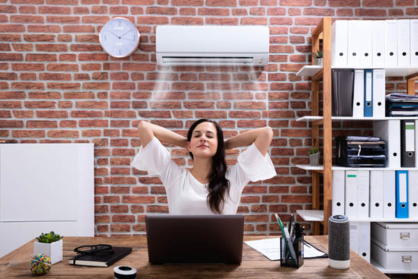 woman enjoying ductless air conditioner