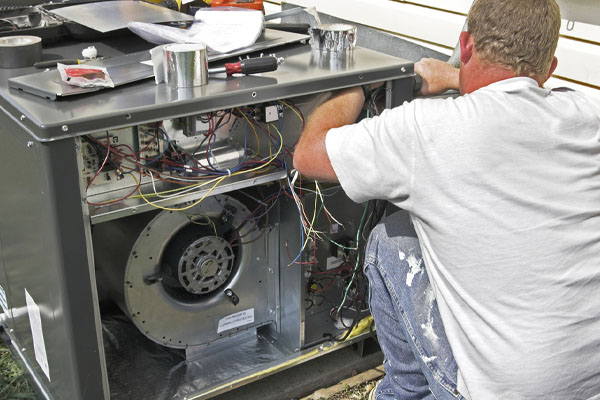 image of an hvac contractor performing air conditioner installation