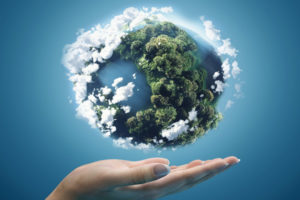 image of hands and plants and globe depicting sustainable energy