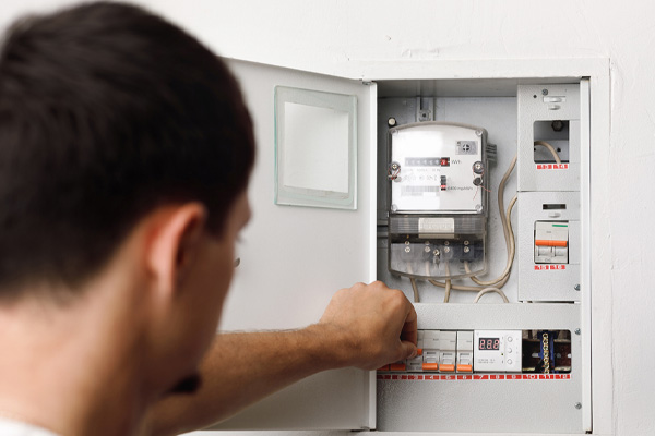 image of homeowner checking furnace circuit