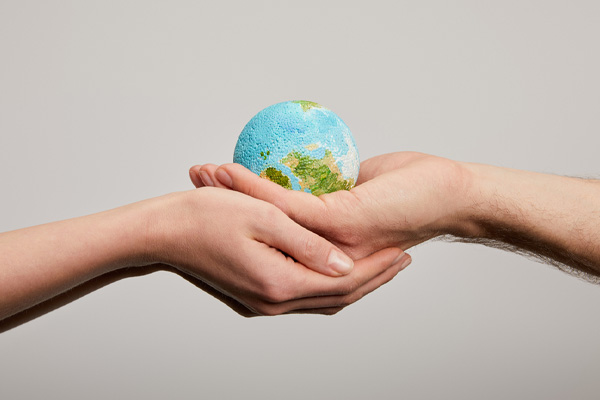 image of hands holding planet depicting bio diesel renewable energy fuel