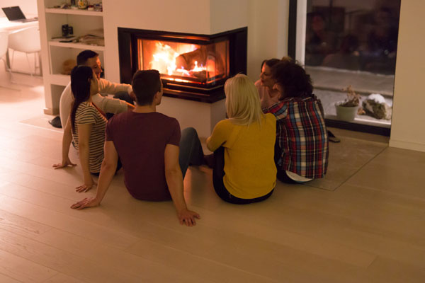 image of a family sitting by a fireplace