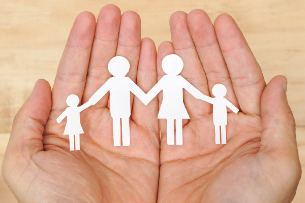 hands holding paper cutout family depicting propane heating safety