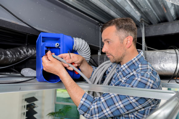 hvac contractor servicing home ventilation system