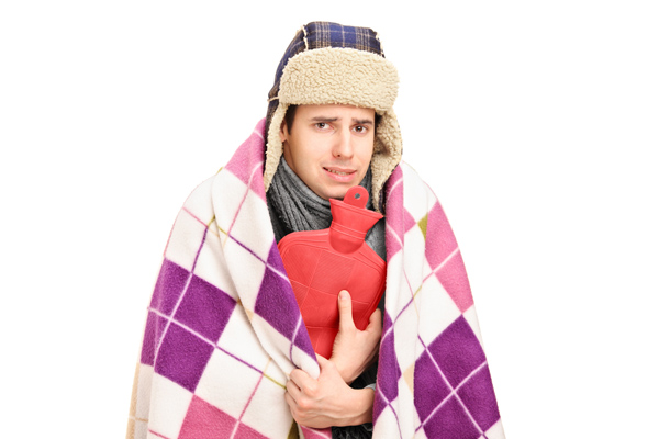 image of a homeowner feeling chilly due to heat pump issues in winter
