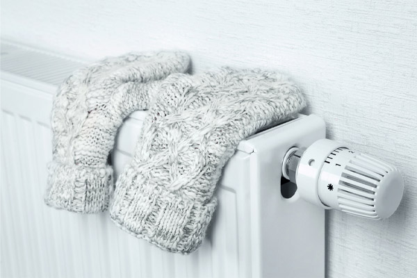 image of mitten on radiator depicting clean efficient Bioheat heating oil