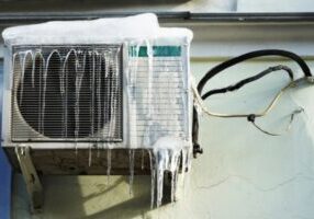 frozen ductless air conditioner outdoor unit in the summer