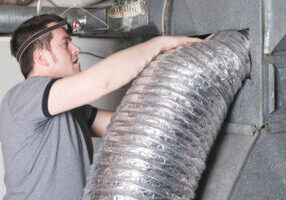 hvac contractor servicing or repairing a home ventilation system