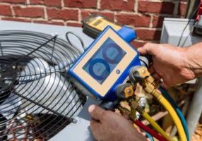 image of an hvac contractor examining an overcharged ac unit