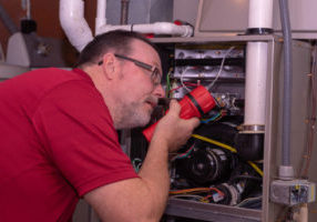 image of an hvac contractor repairing an overheating furnace